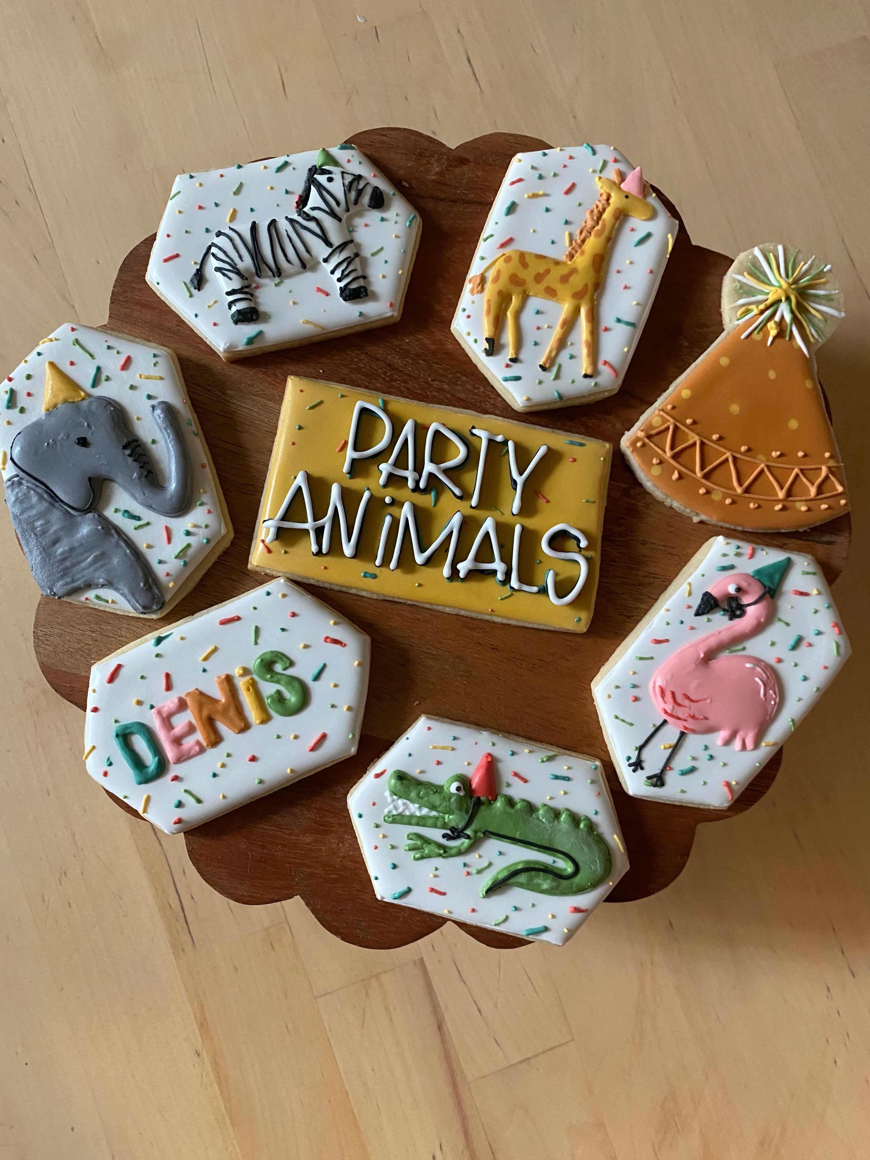 Party Animals themed decorated sugar cookies with zebra, giraffe, elephant, flamingo, and crocodile designs